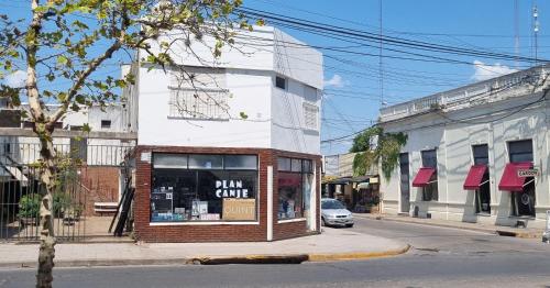 a store with a sign in the window on a street at NidoAparte Departamento Lujan Centro in Luján