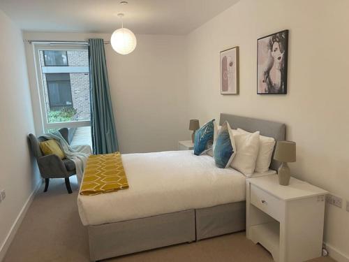 a small bedroom with a bed and a window at BrandNew Luxurious 2Bed Apartmnt in Bexleyheath