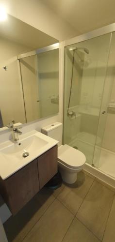 a bathroom with a sink and a toilet and a shower at Bello departamento en costanera de Valdivia in Valdivia