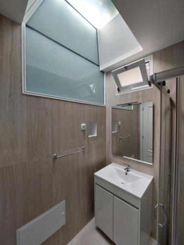 a bathroom with a sink and a mirror at casa da fajã in Funchal