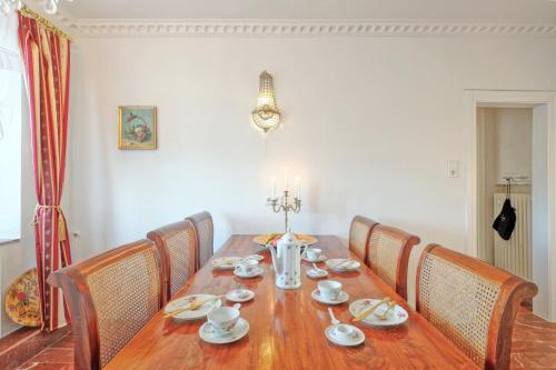 a dining room table with chairs and a wooden tableablish at Nordpalais vor Sylt in Emmelsbüll-Horsbüll