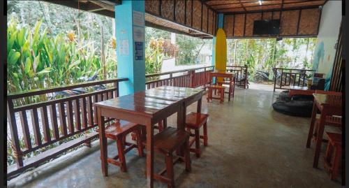 a dining room with tables and chairs in a restaurant at Tres Islas Hostel in General Luna