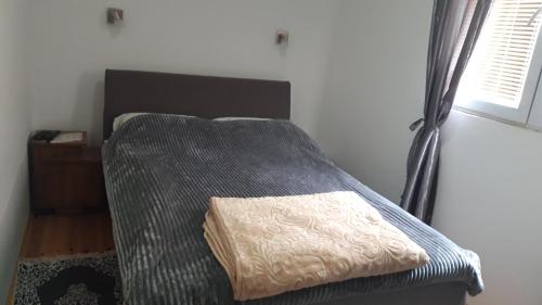 a bed with a pillow on it in a room at GUESTHOUSE TARA in Kolašin
