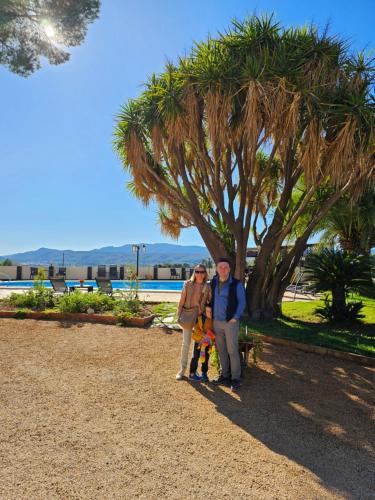 a man and a woman standing next to a tree at B&B Finca la Yuca "Un paraíso en Ontinyent" in Ontinyent