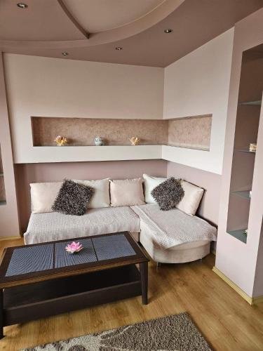 a living room with a couch and a coffee table at Apartament Poręba in Lublin