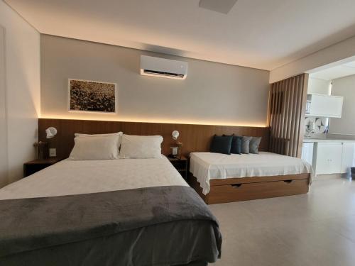 a hotel room with two beds and a tv at Garvey Park Hotel - Quarto Premium 409 in Brasília