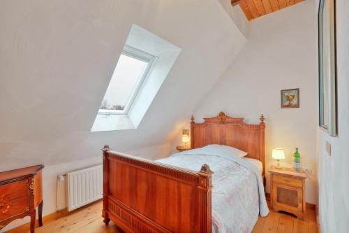 a bedroom with a wooden bed and a window at Nordpalais vor Sylt in Emmelsbüll-Horsbüll