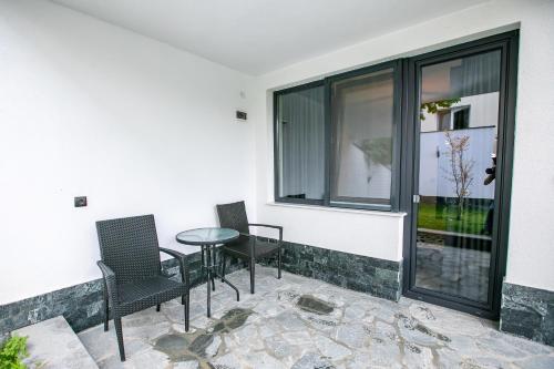 a patio with chairs and a table and a window at Apartment Dafni in Sandanski