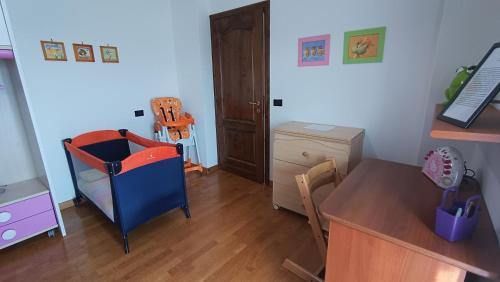 a childs room with a table and a desk and a dining room at La casa di Panfilo in Sulmona