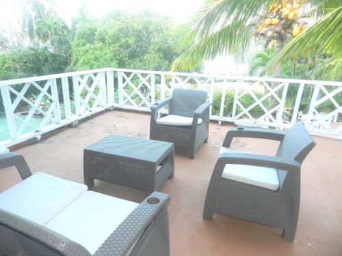 a patio with chairs and tables on a balcony at Ocean View Sai in San Andrés