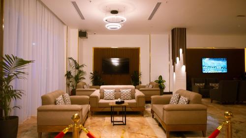 a lobby with couches and a flat screen tv at فندق سنبات بلاتينيوم in Jazan
