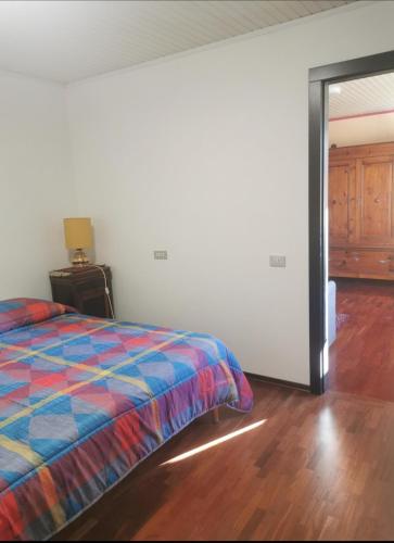 a bedroom with a bed and a wooden floor at B&B La Chicca in Ravenna