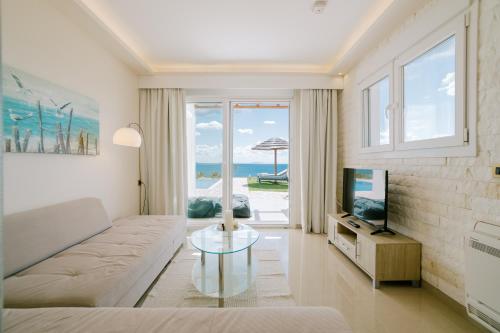 a living room with a couch and a television at The Three Graces in Antimácheia