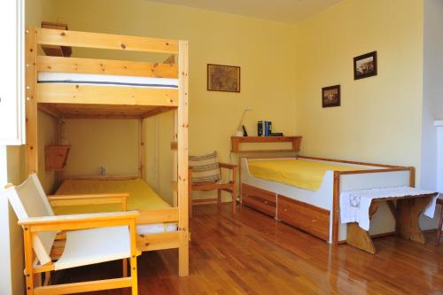 a bedroom with two bunk beds and a desk at Villa Ana in Rab