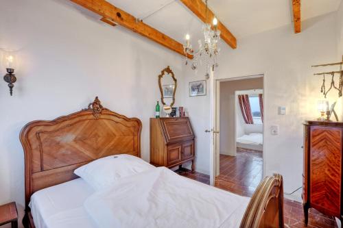 a bedroom with a bed and a chandelier at Nordpalais vor Sylt in Emmelsbüll-Horsbüll