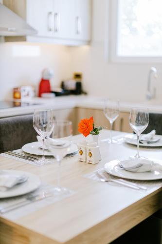 a table with wine glasses and plates on a kitchen counter at The Three Graces in Antimácheia