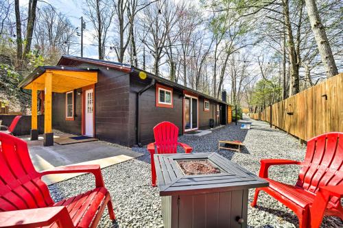 a group of red chairs and a small cabin at Multi-Unit Brevard Vacation Rental with Patio! in Brevard