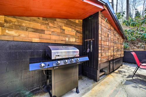 a outdoor kitchen with a stove and a grill at Multi-Unit Brevard Vacation Rental with Patio! in Brevard