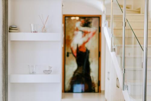 a hallway with a picture of a woman dancing at The Three Graces in Antimácheia