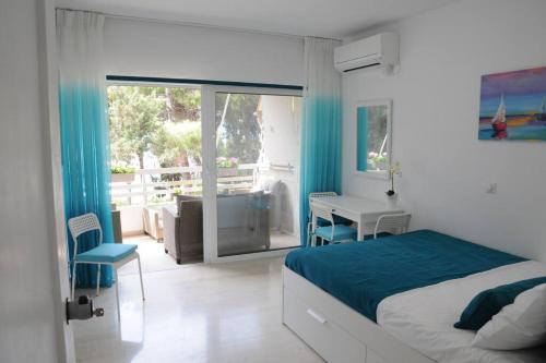 um quarto com uma cama, uma secretária e uma janela em ALBATROS em Loutraki