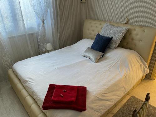 a bed with two pillows and a red bag on it at Casa Victoria in Castelletto sopra Ticino