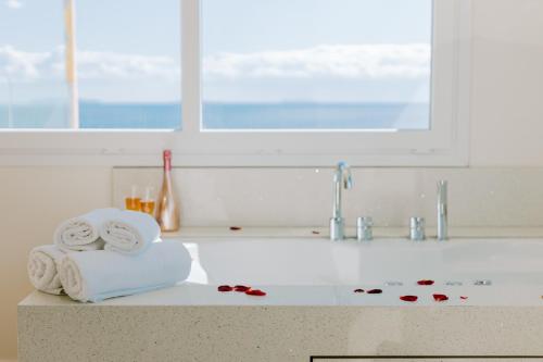 a kitchen counter with towels and a sink at The Three Graces in Antimácheia