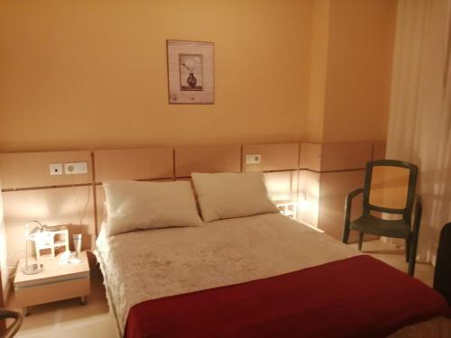 a hotel room with a bed and a chair at Magic World Aguamarina in Oropesa del Mar