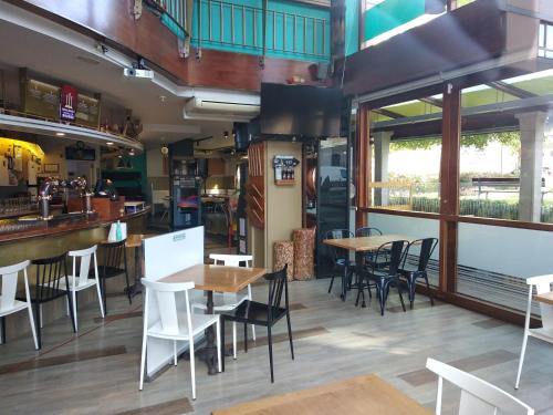 a restaurant with tables and chairs and a bar at Hostal Bríos in Lugo