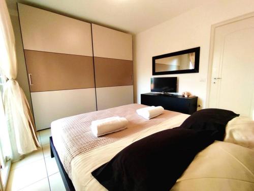 a bedroom with a large bed with two pillows on it at VistaMare Bluemar - The Art of the Sea - 105mq in Cattolica
