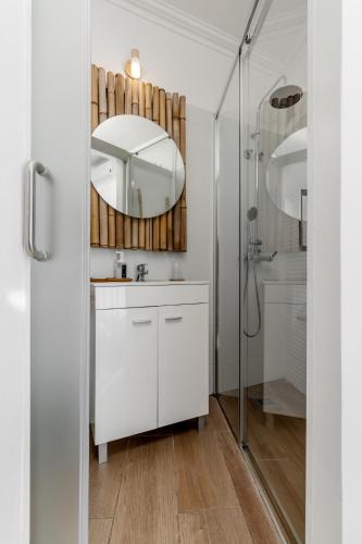 a bathroom with a white vanity and a mirror at Villa Center - Alojamento Local in Grândola
