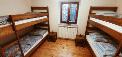 a room with three bunk beds and a window at Apartmaji Pajer in Koper