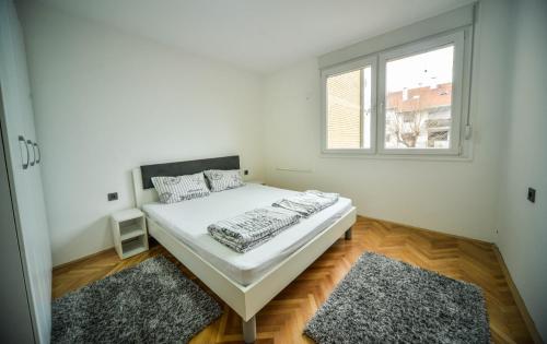Habitación blanca con cama y ventana en goltepirot, en Pirot