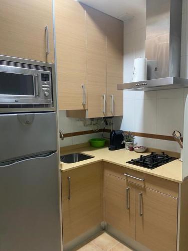 a small kitchen with a sink and a microwave at Apartamento casco histórico in Zamora