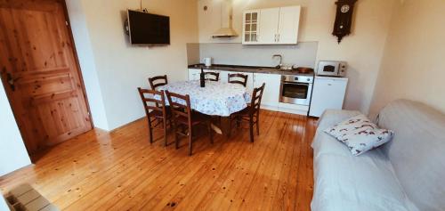 a kitchen with a table and chairs in a room at Apartmaji Pajer in Koper