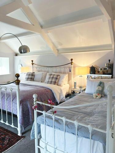 a bedroom with a white bed in a room at Dylan Thomas Sea View in Laugharne