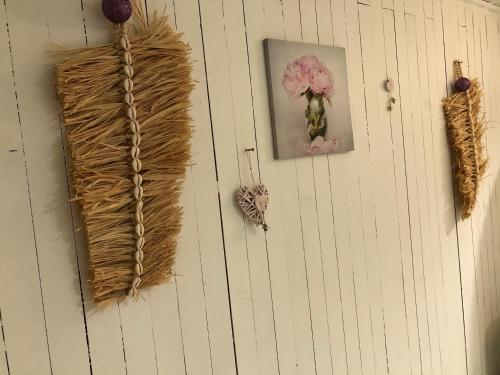 a wall with a bunch of different items on it at Le Nid du bois d'Oingt in Le Bois-dʼOingt