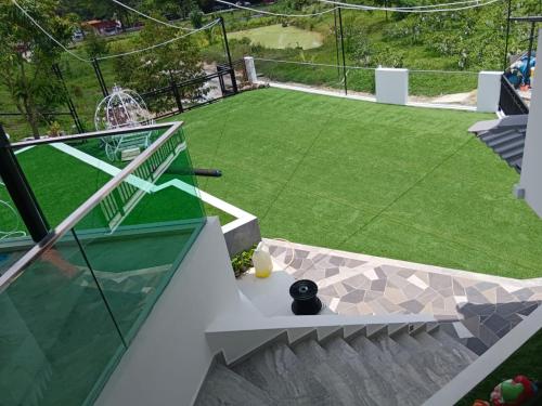 an image of a backyard with a artificial lawn at I Do Farmstay in Bukit Mertajam