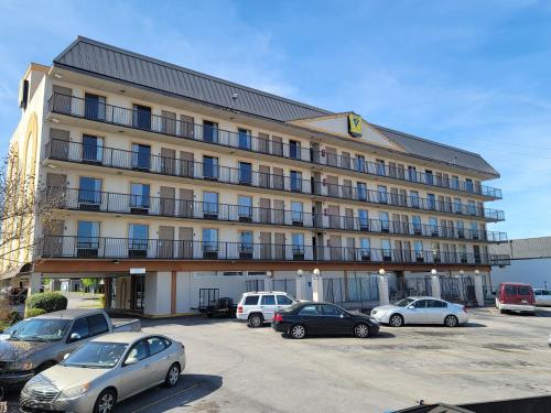 a large building with cars parked in a parking lot at Studio 9 Inn & Suites in Decatur