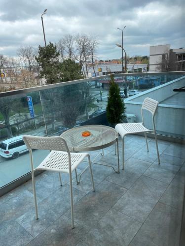 a patio with two chairs and a table on a roof at Dany Studio in Eforie Nord