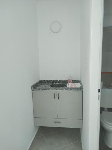 a bathroom with a sink and a toilet at Departamento Mexico in Cedro