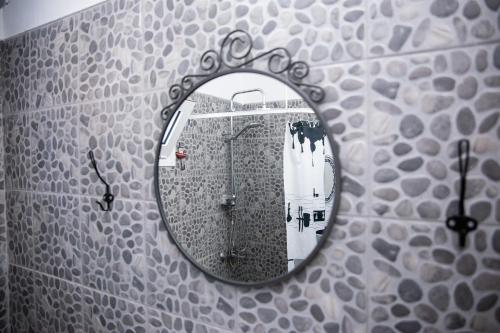 a mirror on the wall of a bathroom with a shower at SUN'S HOUSE in Asprovalta