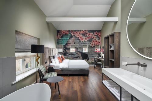 ein Hotelzimmer mit einem Bett und einem Bad in der Unterkunft Boutique Hotel Brasa Beemster in Middenbeemster