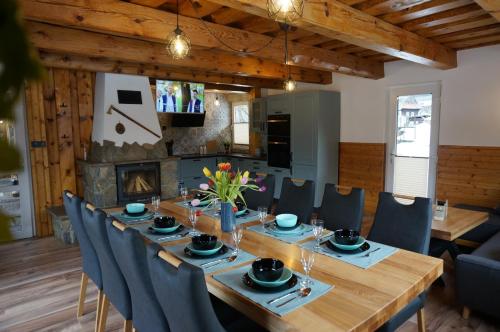 a dining room with a long wooden table and chairs at Penzion a drevenica pri Hati in Terchová