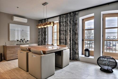 a kitchen with a table and some windows at Les Immeubles Charlevoix - Le 1172 in Quebec City