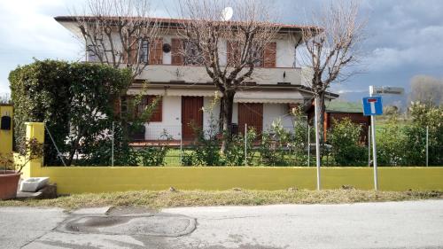a yellow fence in front of a house at Verdazzurro in Camaiore