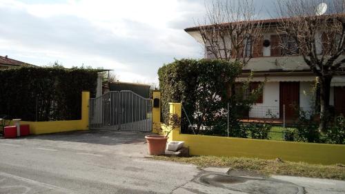 a yellow fence in front of a house at Verdazzurro in Camaiore