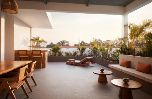 a large living room with a table and chairs at Plantation Urban Resort & Spa in Phnom Penh
