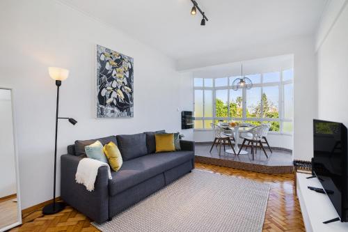 a living room with a couch and a table at WHome Peaceful River Views in Algés perfect for Families in Algés