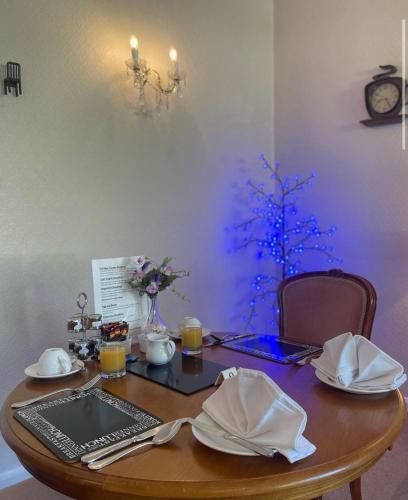 a table with a laptop and a blue christmas tree at The Southbourne Villa in Torquay
