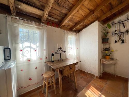 a kitchen with a wooden table and a window at Casa Fidelina I Miraflores de la Sierra in Madrid